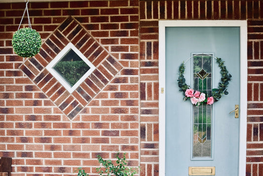 white wooden window with red flowers